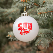 White SUU Christmas ornament hanging on a tree on campus.